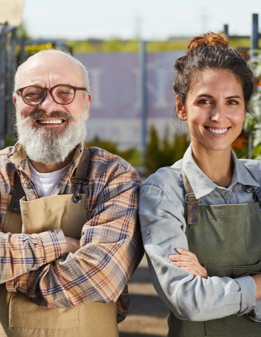 happy small business owners wearing aprons